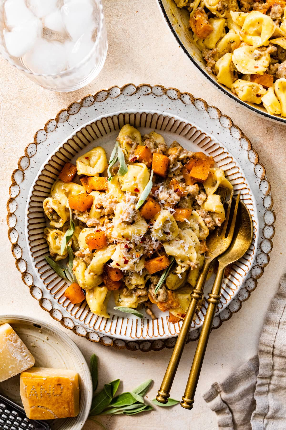 Creamy Tortellini with Butternut Squash & Sausage on plate with silverware. 