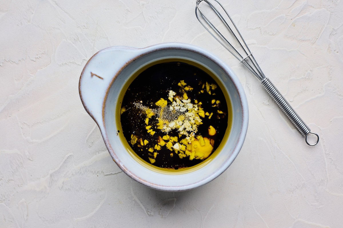 maple mustard dressing in bowl with whisk. 