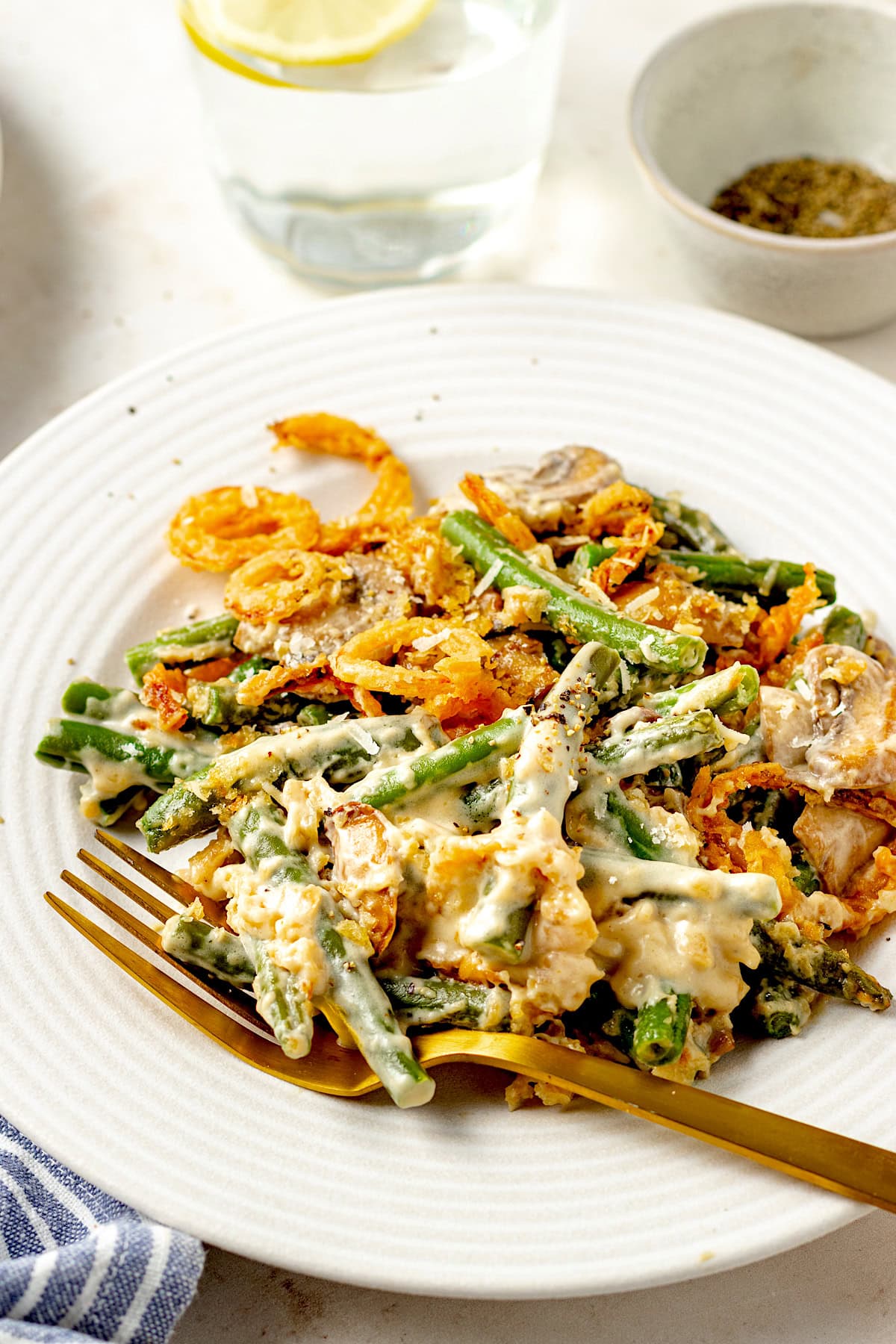 green bean casserole on plate with fork. 