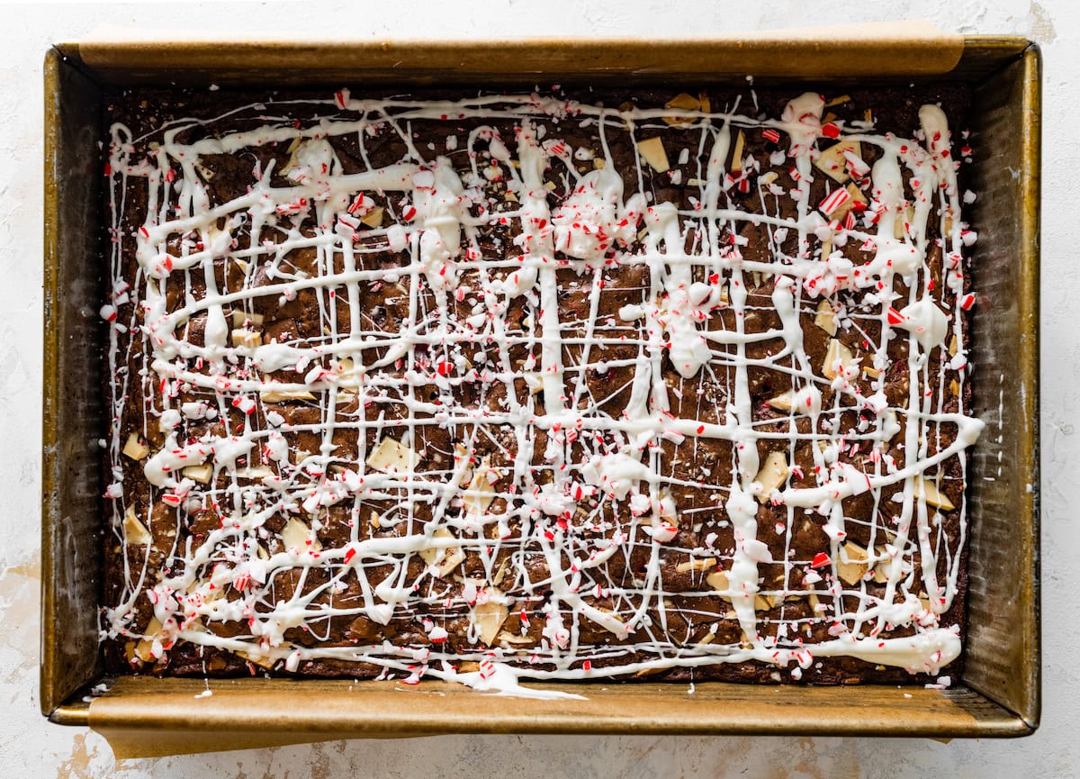 peppermint bark brownies drizzled with white chocolate and sprinkled with peppermint candy. 