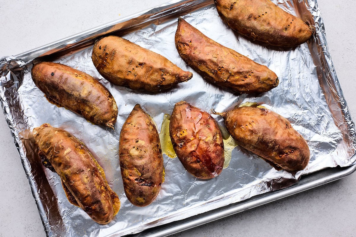 baked sweet potatoes on baking sheet. 