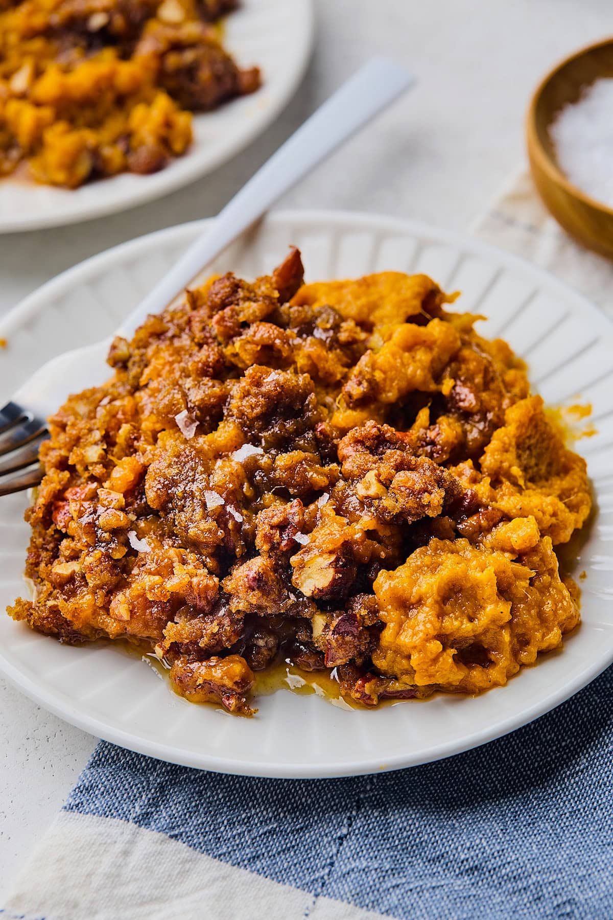 sweet potato casserole on plate with fork. 