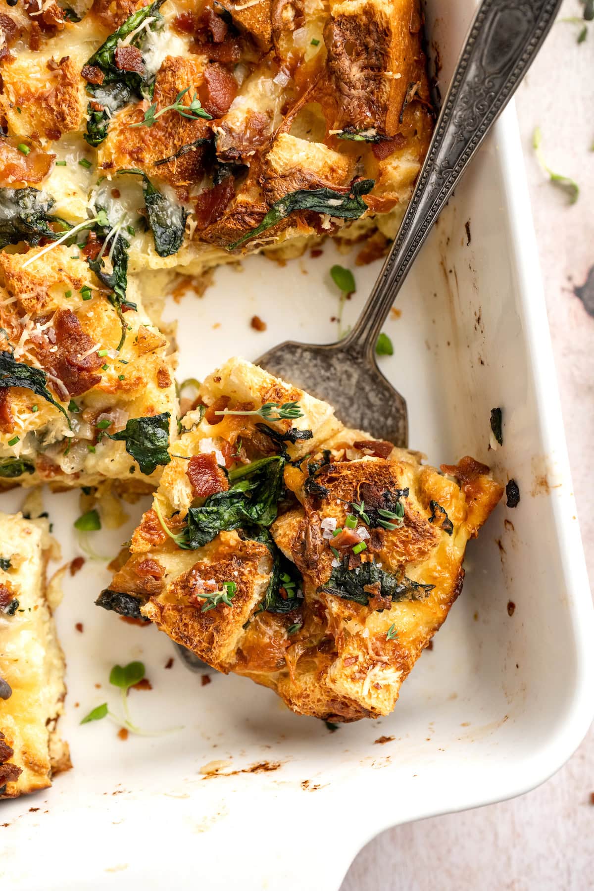 piece of breakfast strata in pan with spatula. 