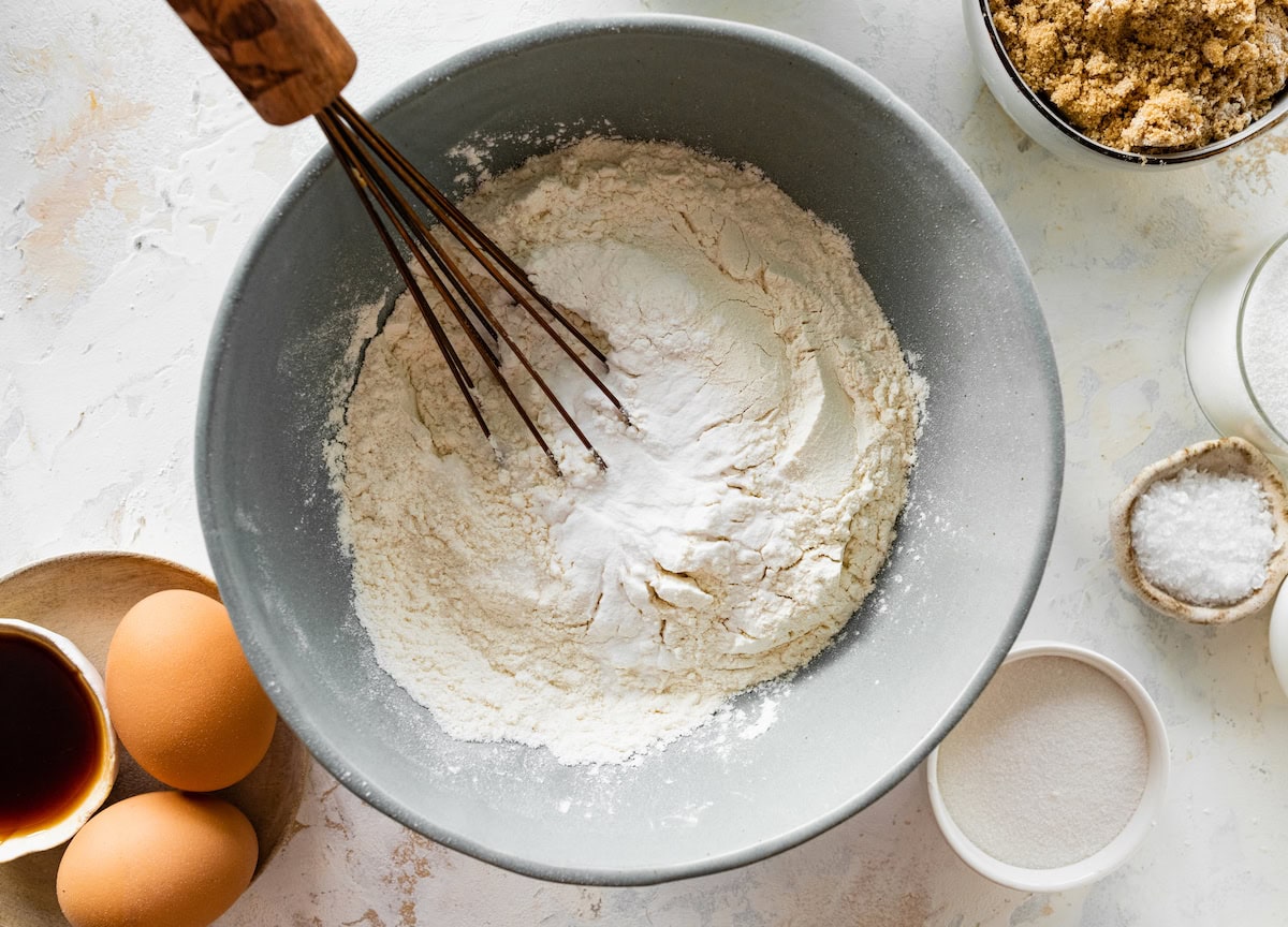 dry ingredients being whisked together in mixing bowl. 