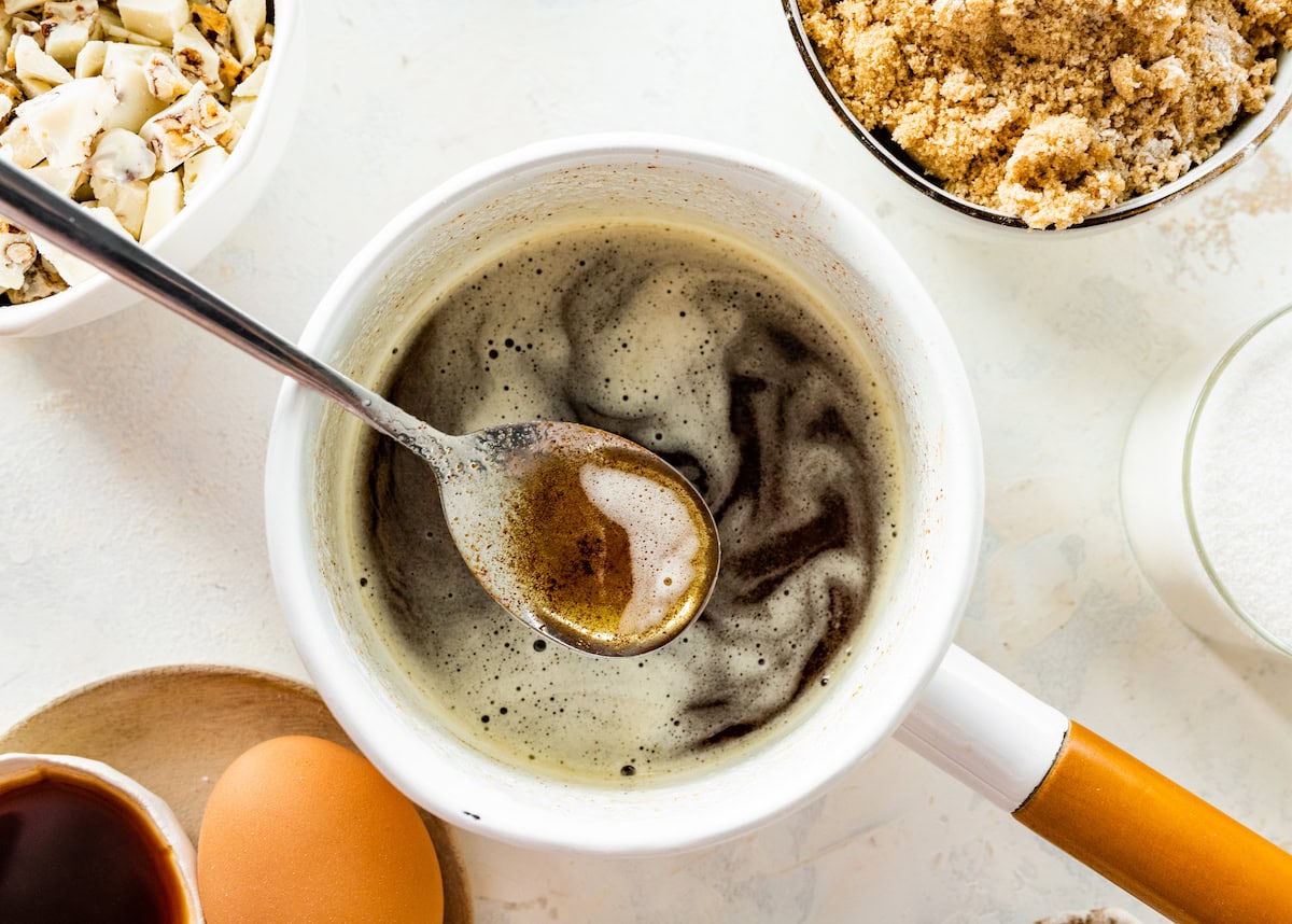 brown butter in saucepan with spoon. 