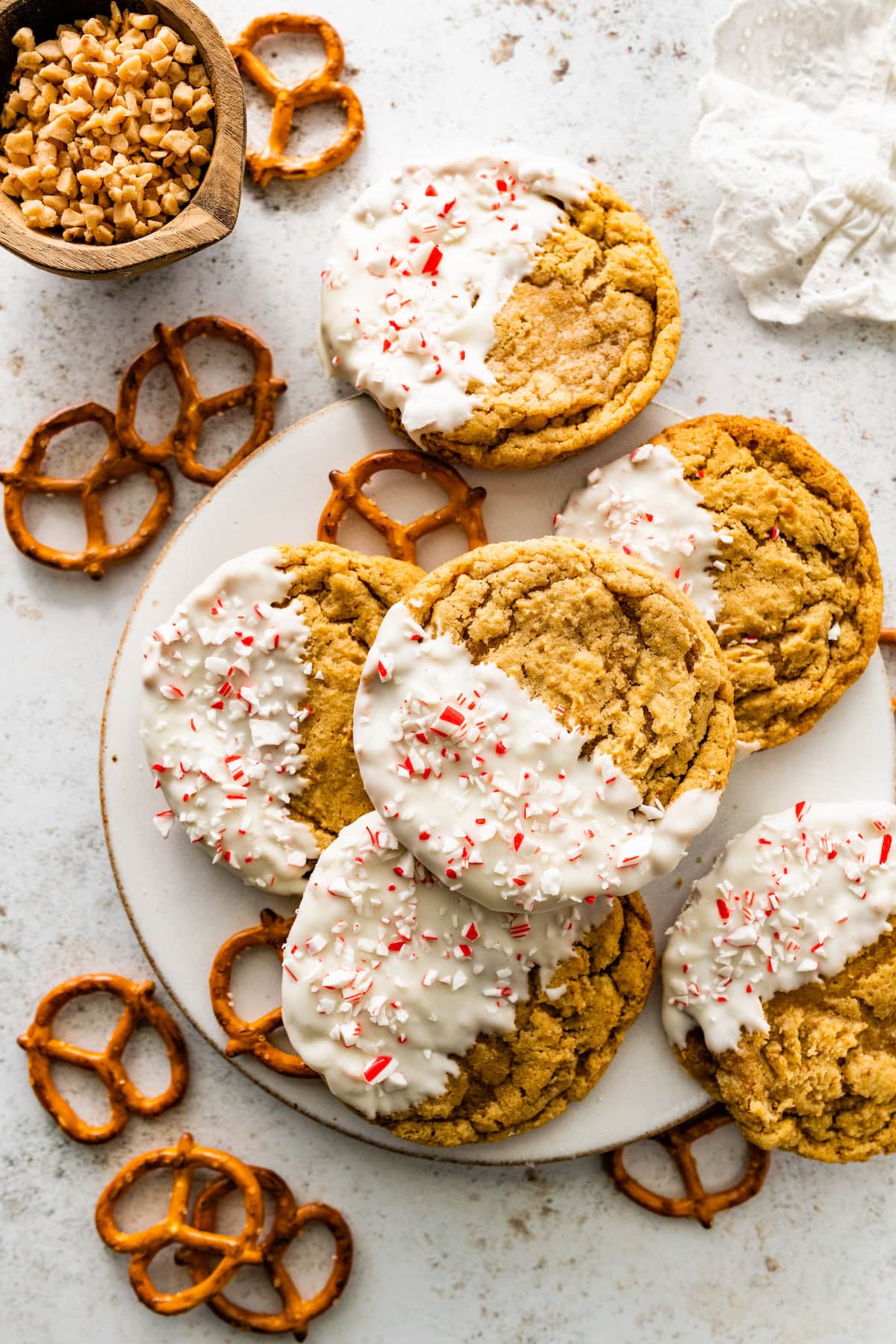 white chocolate dipped pretzel cookies with crushed peppermint. 