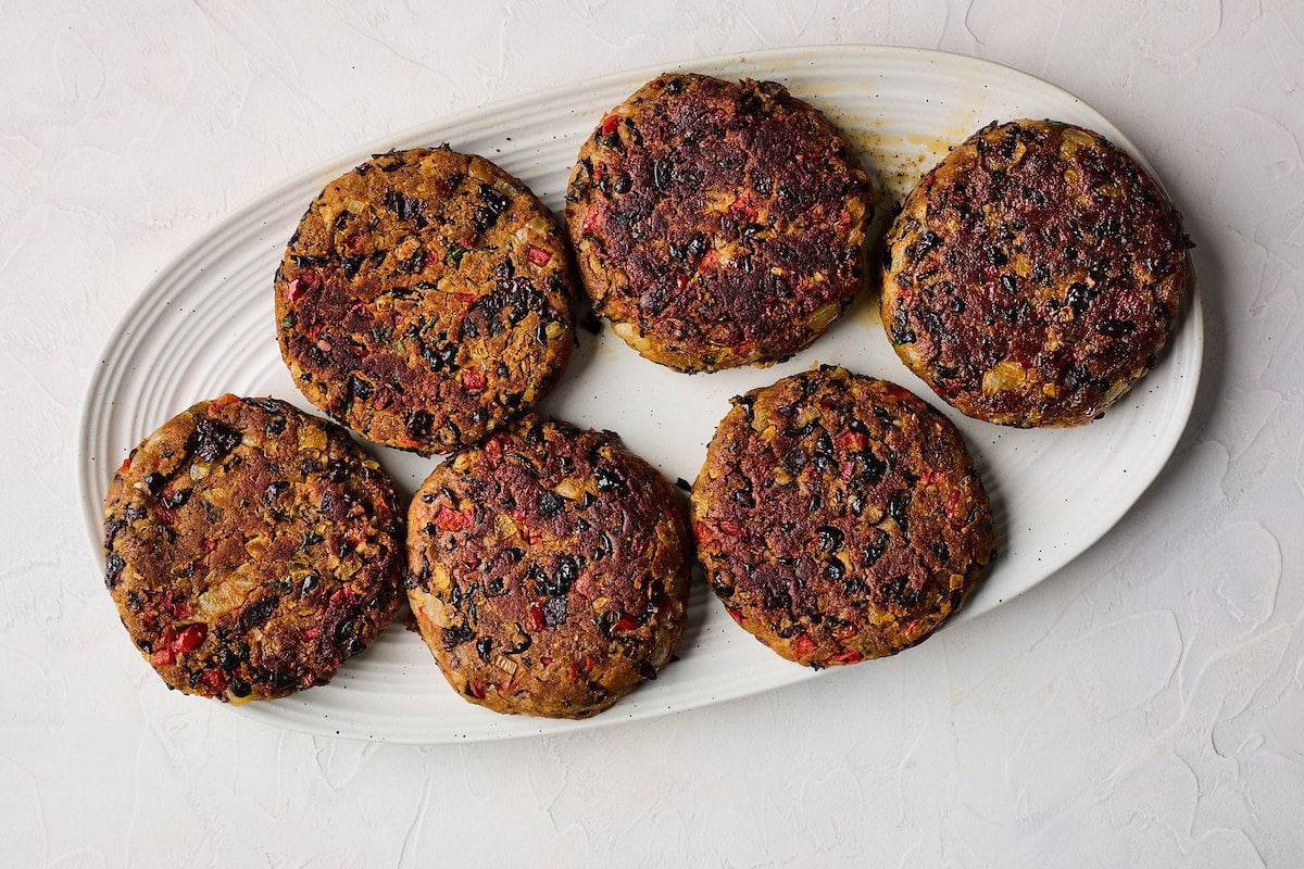 cooked black bean burgers on plate. 