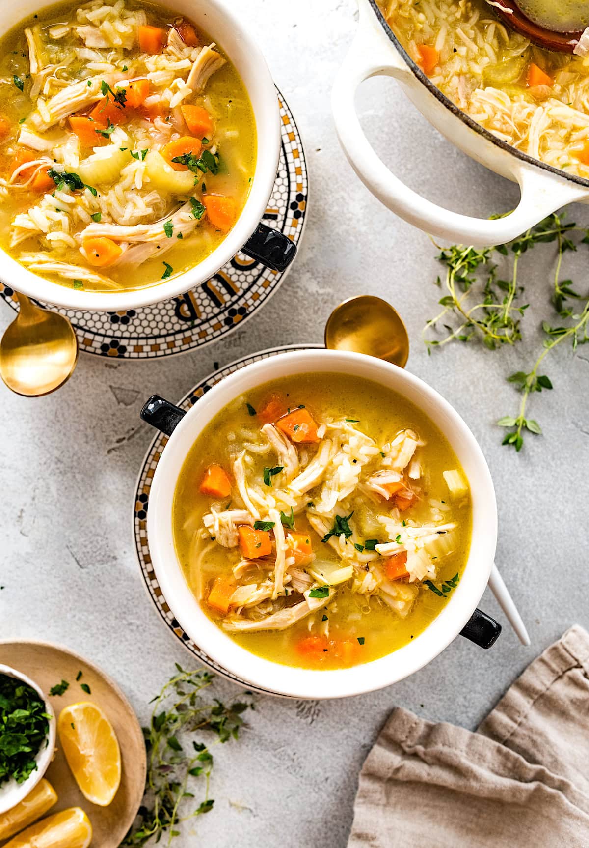 Two bowls of chicken and rice soup. 