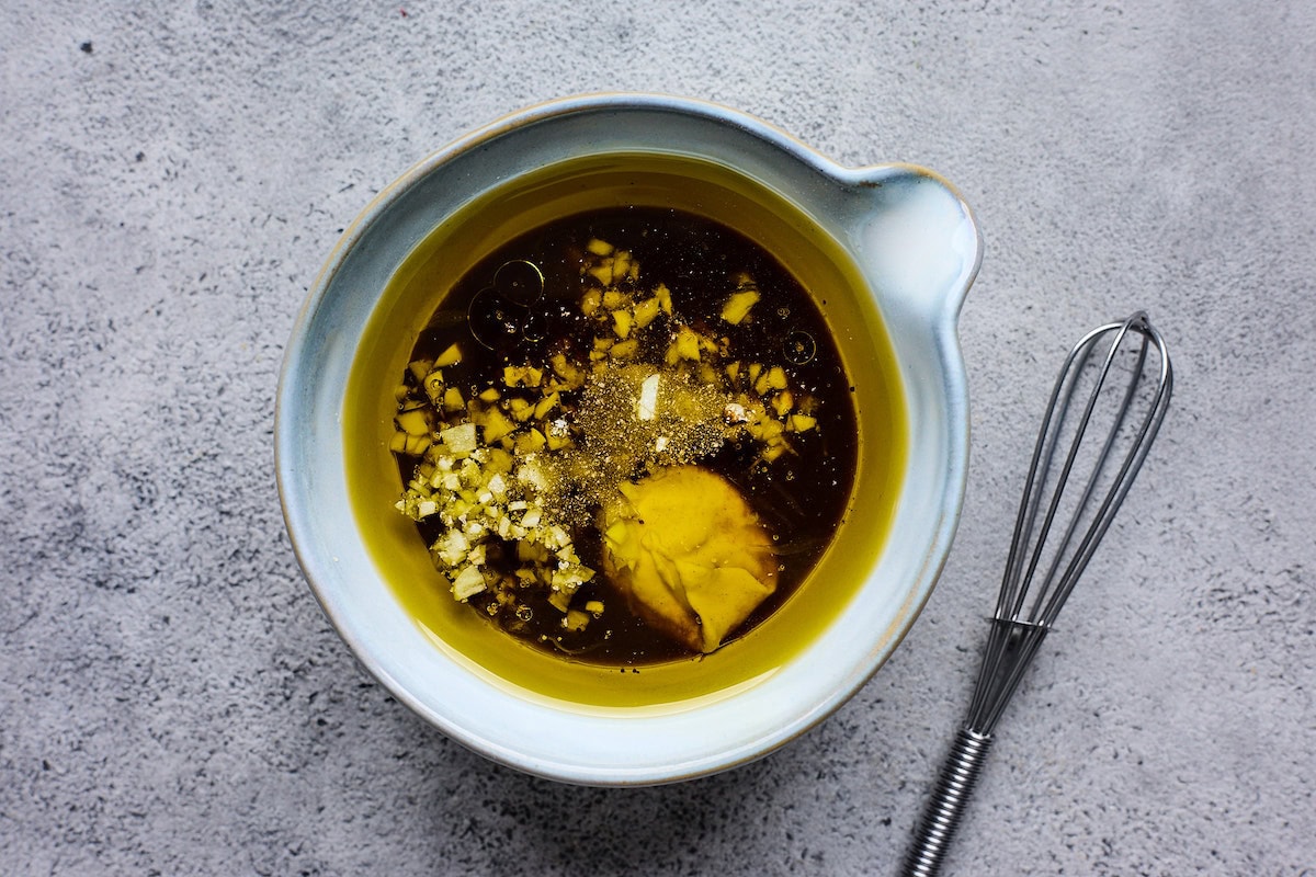 balsamic dressing ingredients in bowl ready to be whisked together. 