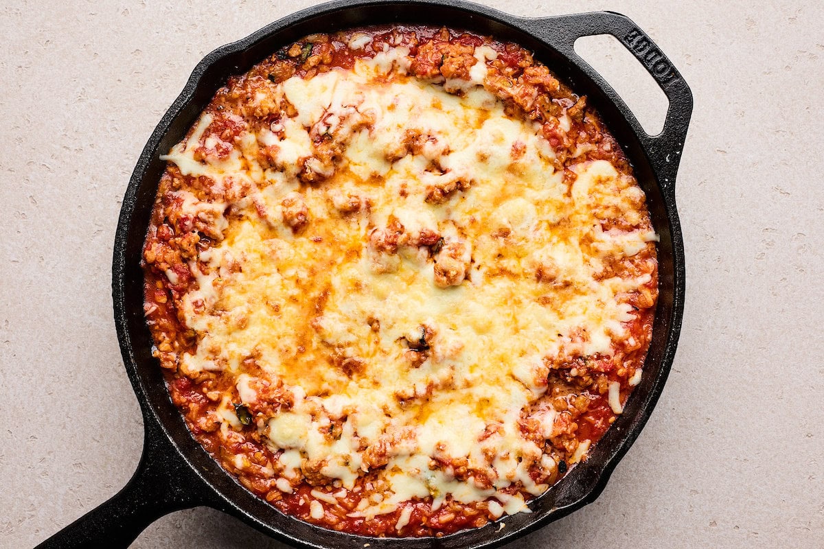 Cheesy Ground Turkey Rice Skillet with Marinara Sauce in cast iron skillet. 