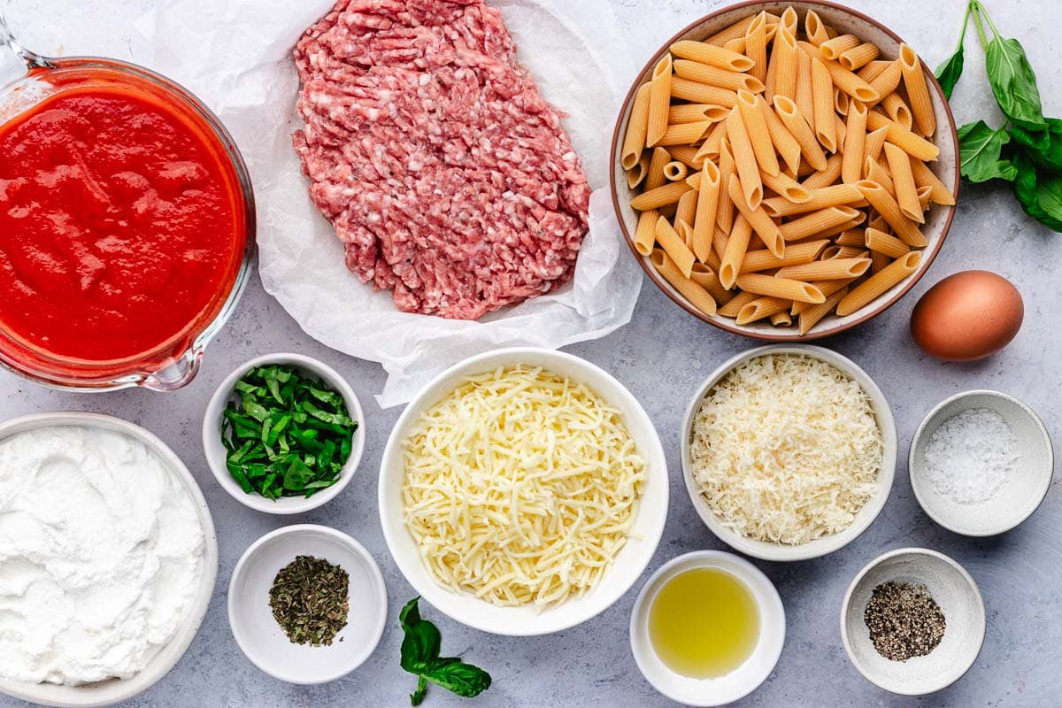 baked ziti ingredients in bowls. 