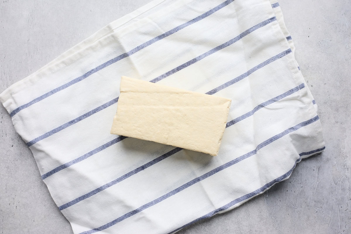 tofu block on towel to drain out liquid. 