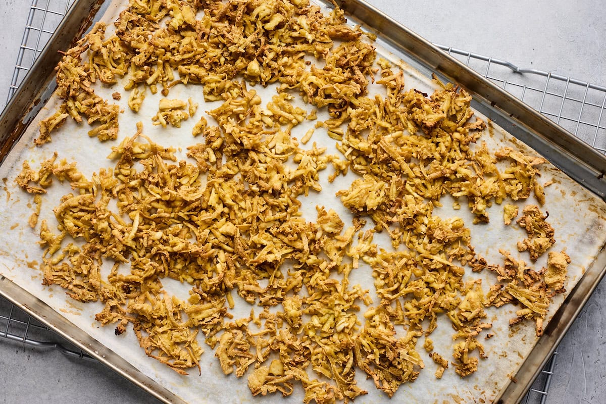 crispy shredded tofu on baking sheet with parchment paper. 