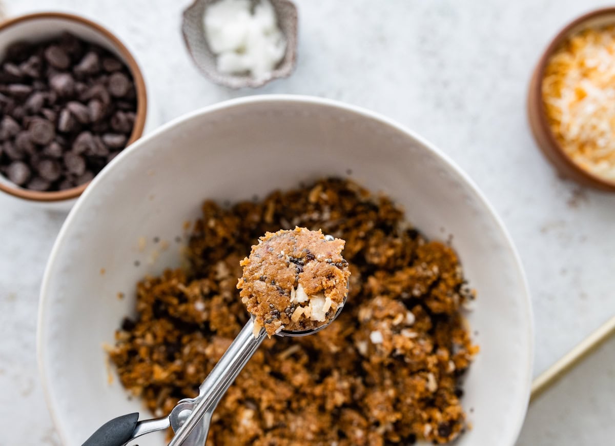 samoa cookie protein ball being scooped into balls with cookie scoop. 