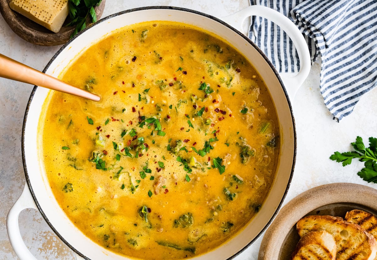 sausage kale white bean soup in pot with ladle. 