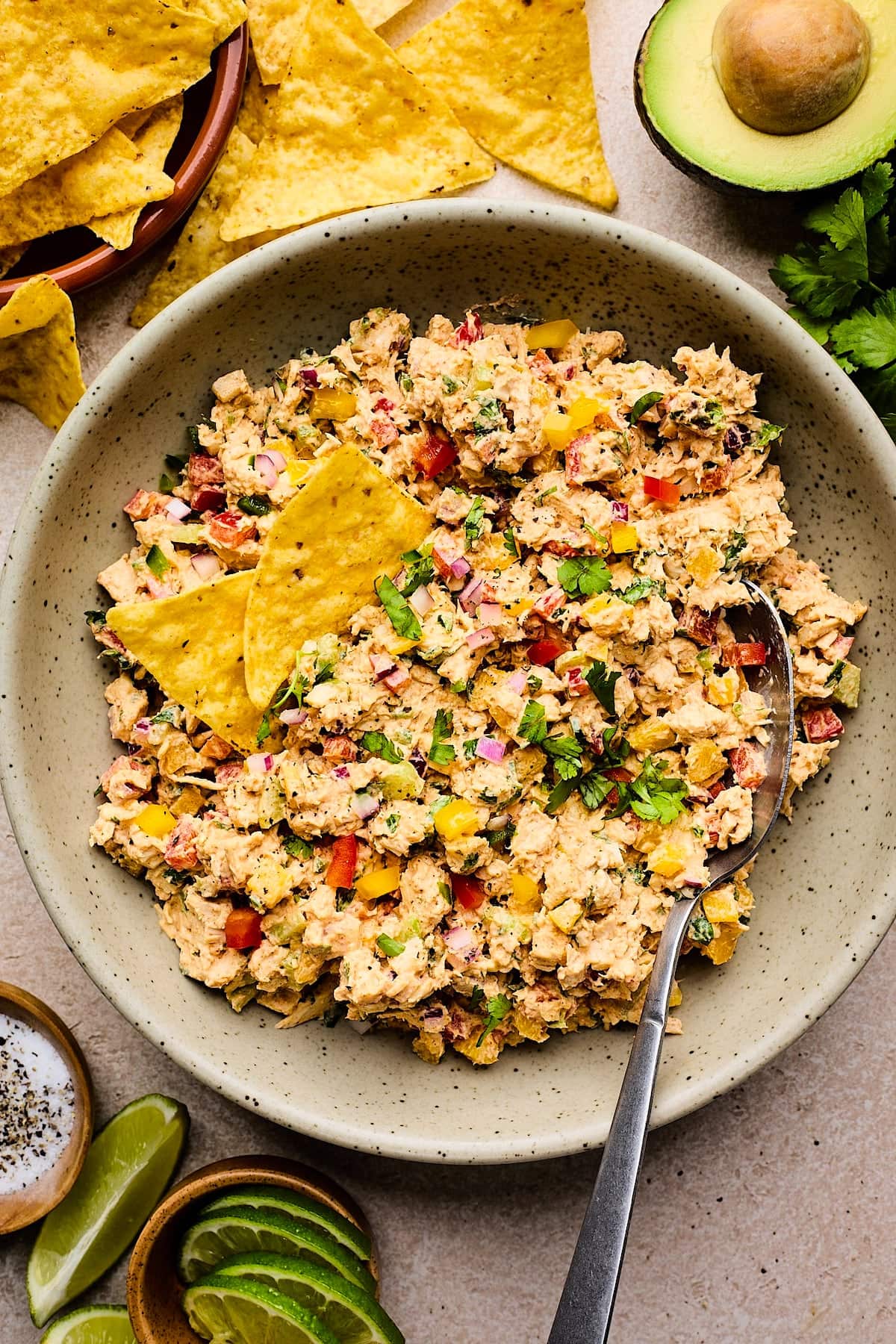 taco chicken salad with chips in bowl with spoon. 