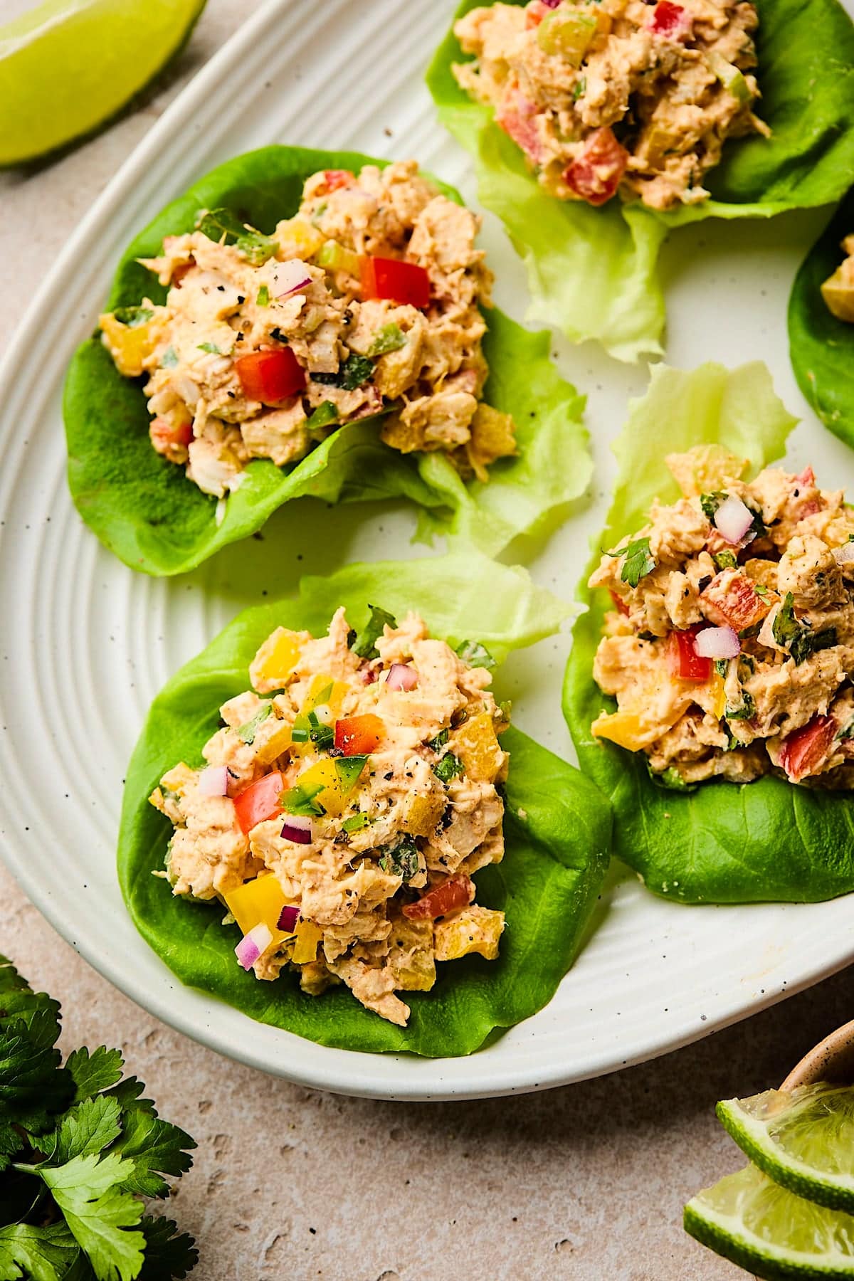 taco chicken salad in lettuce cups on plate. 