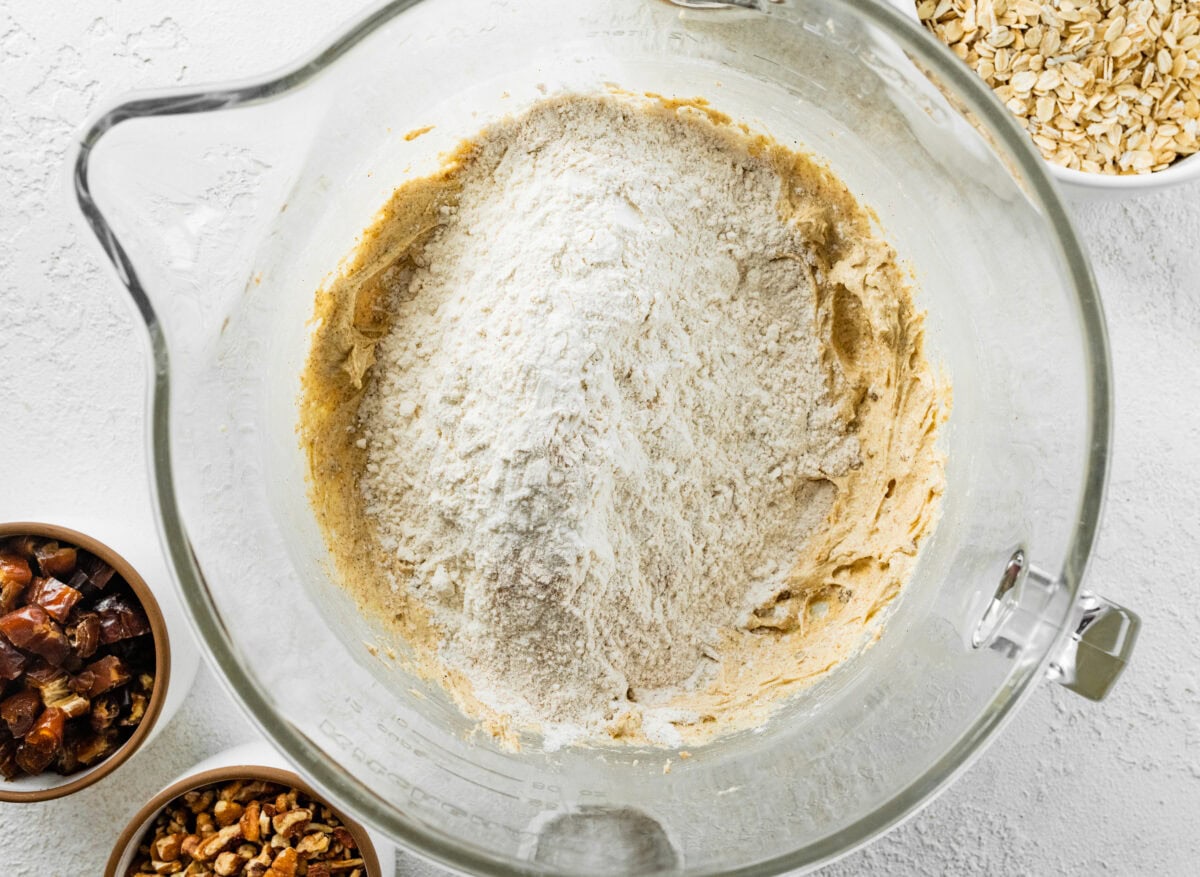 dry ingredients being added to wet ingredients in mixing bowl. 