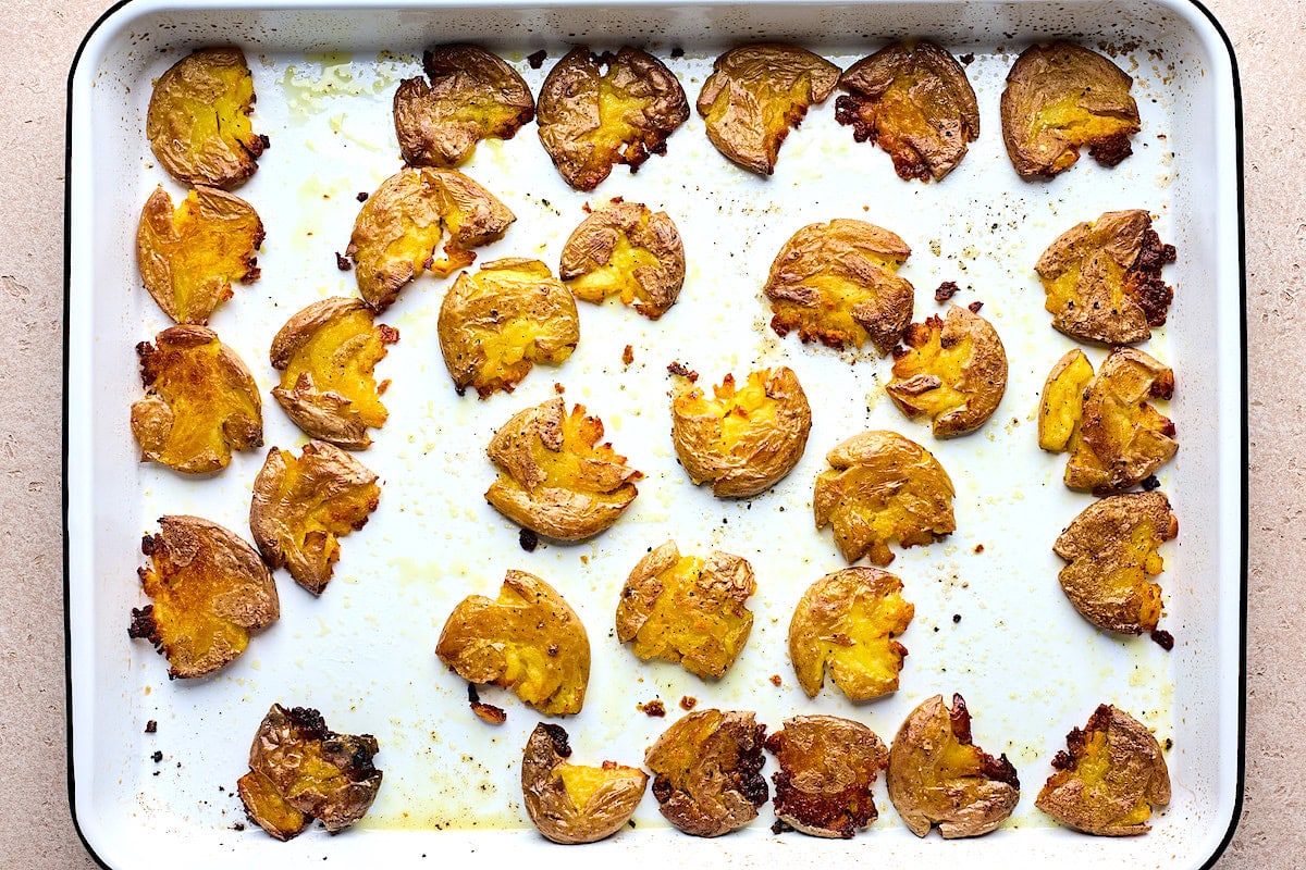 crispy smashed potatoes on baking sheet. 